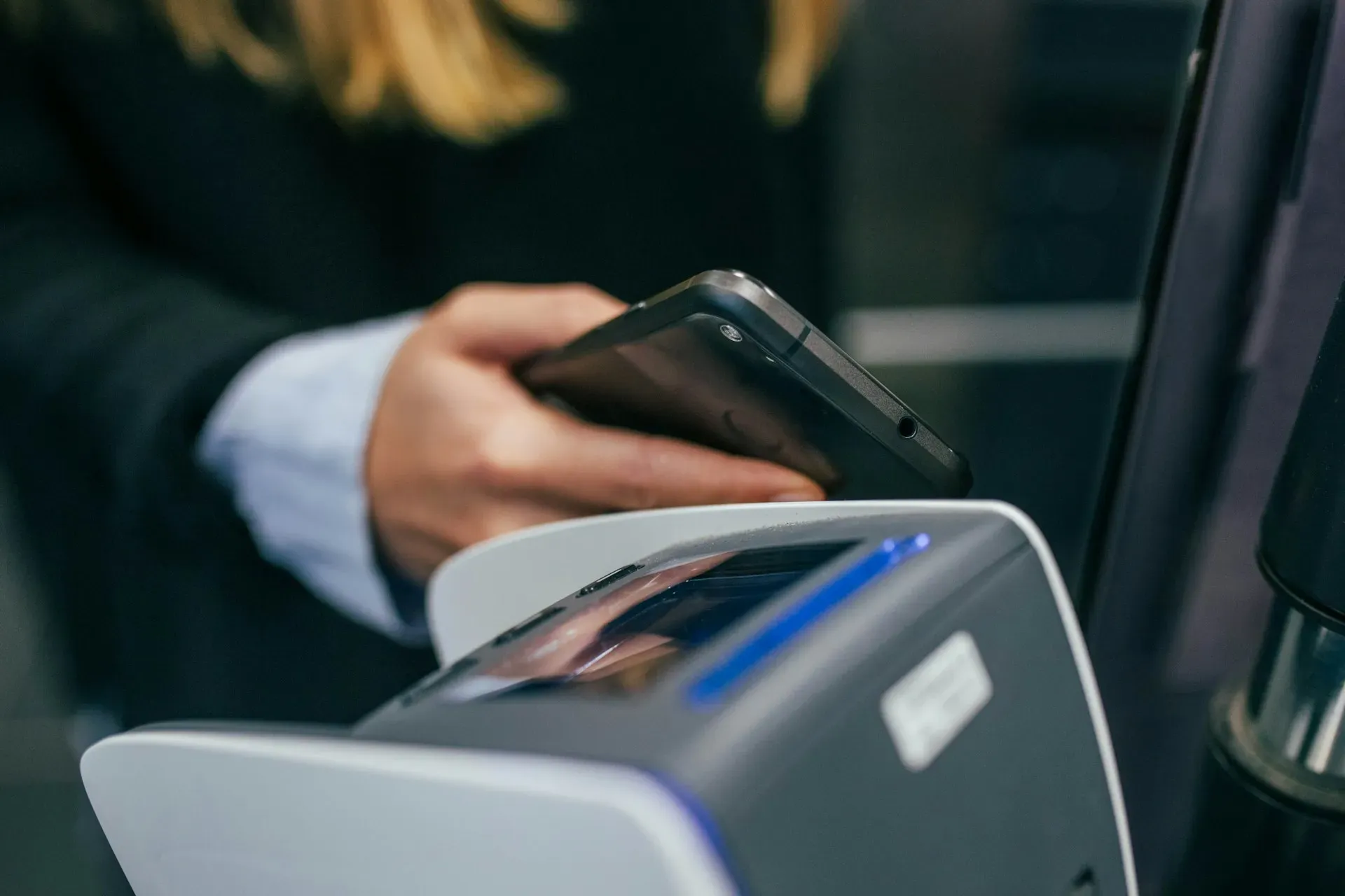 Man paying with phone on checkout